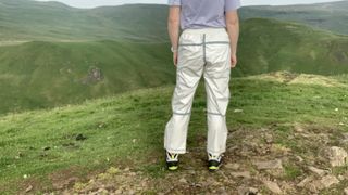 Rear view of hiker wearing cream rain pants