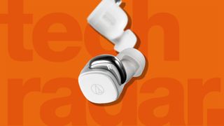 A pair of the best budget wireless earbuds from Audio Technica against a orange TechRadar background