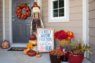 front porch decorated with ceramic pumpkins for fall