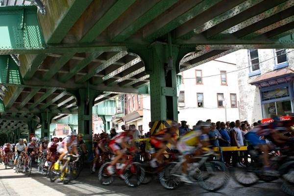 The men pass under train tracks just before hitting the wall.