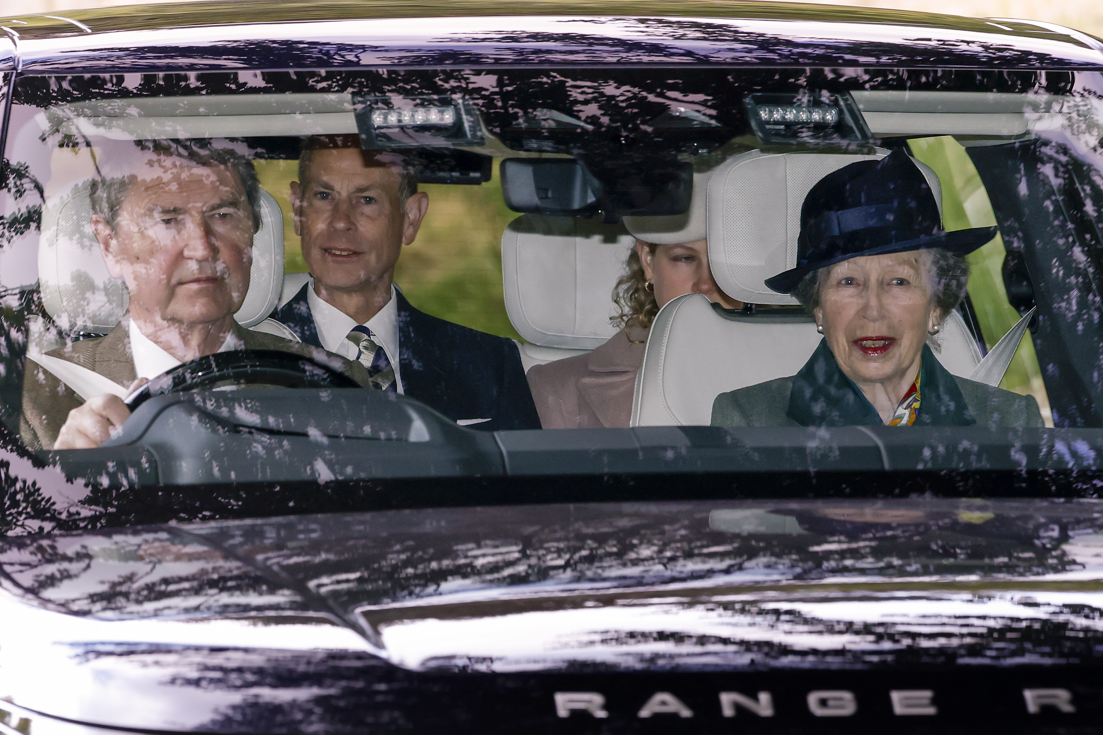 Princess Anne, Sir Tim Laurence, Prince Edward and Lady Louise riding in a car