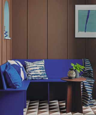 Banquette in navy blue with deep brown wall behind