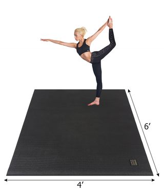 woman doing yoga on large mat