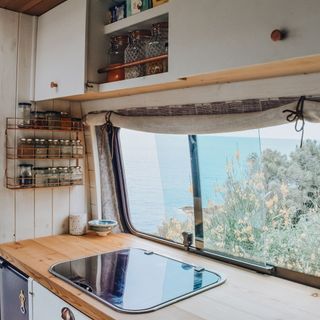 kitchen with wooden worktop and white cabinet