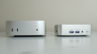 The Geekom A6 next to the Mac mini M4 showing the front ports of both devices