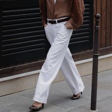 woman in white jeans and brown shirt