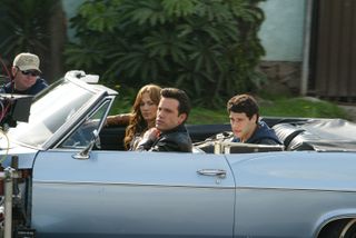 Jennifer Lopez and Ben Affleck ride in a blue car while filming 2003 movie Gigli