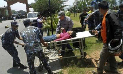 An unidentified survivor of a plane crash in Nepal is rushed to the hospital on May 14. The plane crashed into a mountain in the Himalayas while trying to land, killing 15 people.
