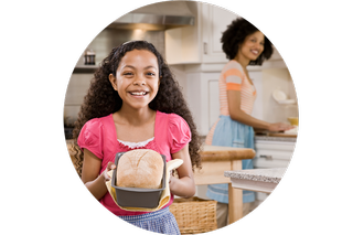 A girl holding a loaf of bread