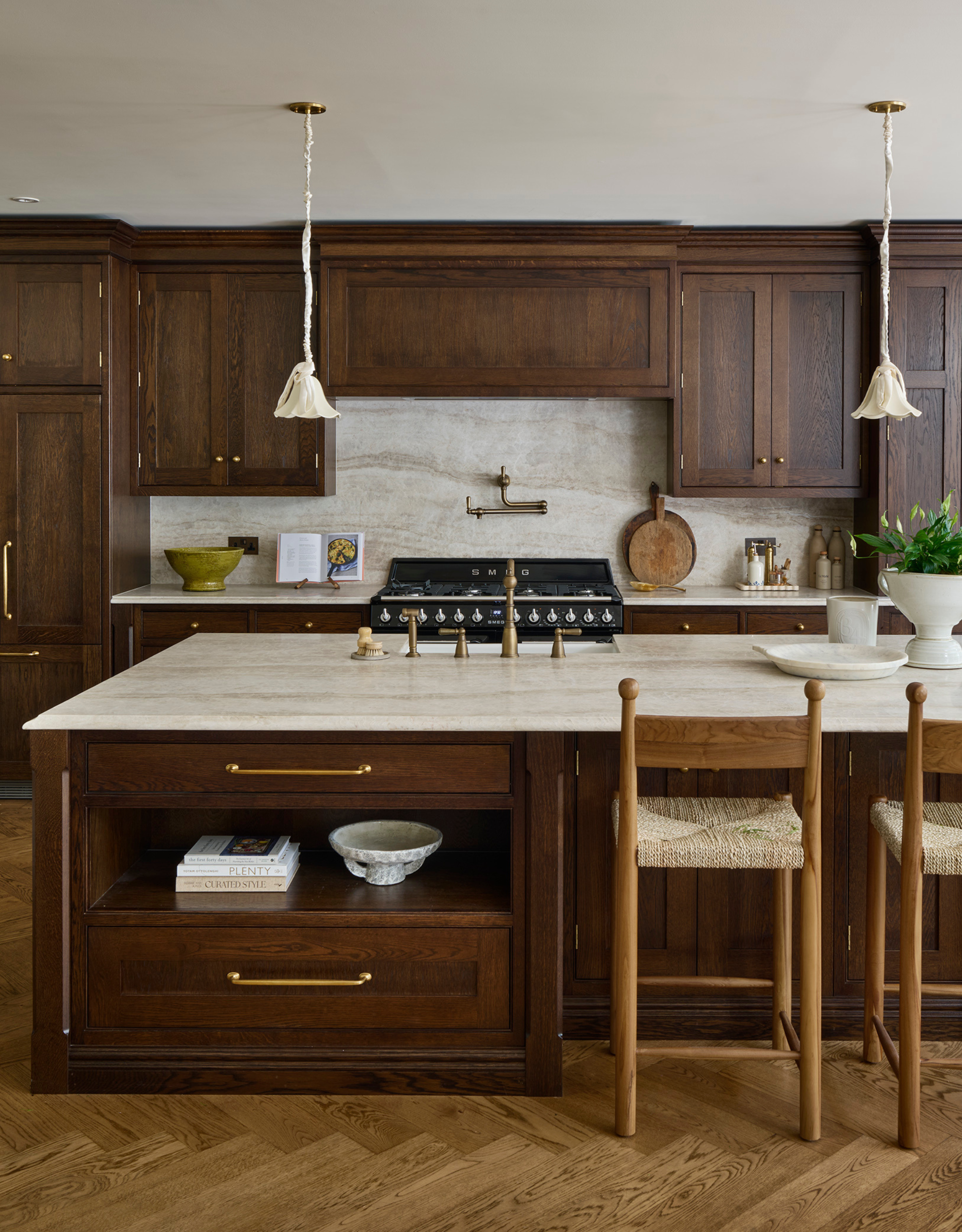 dark wooden cabinetry with bronze hardware, stone counters and antique decor items