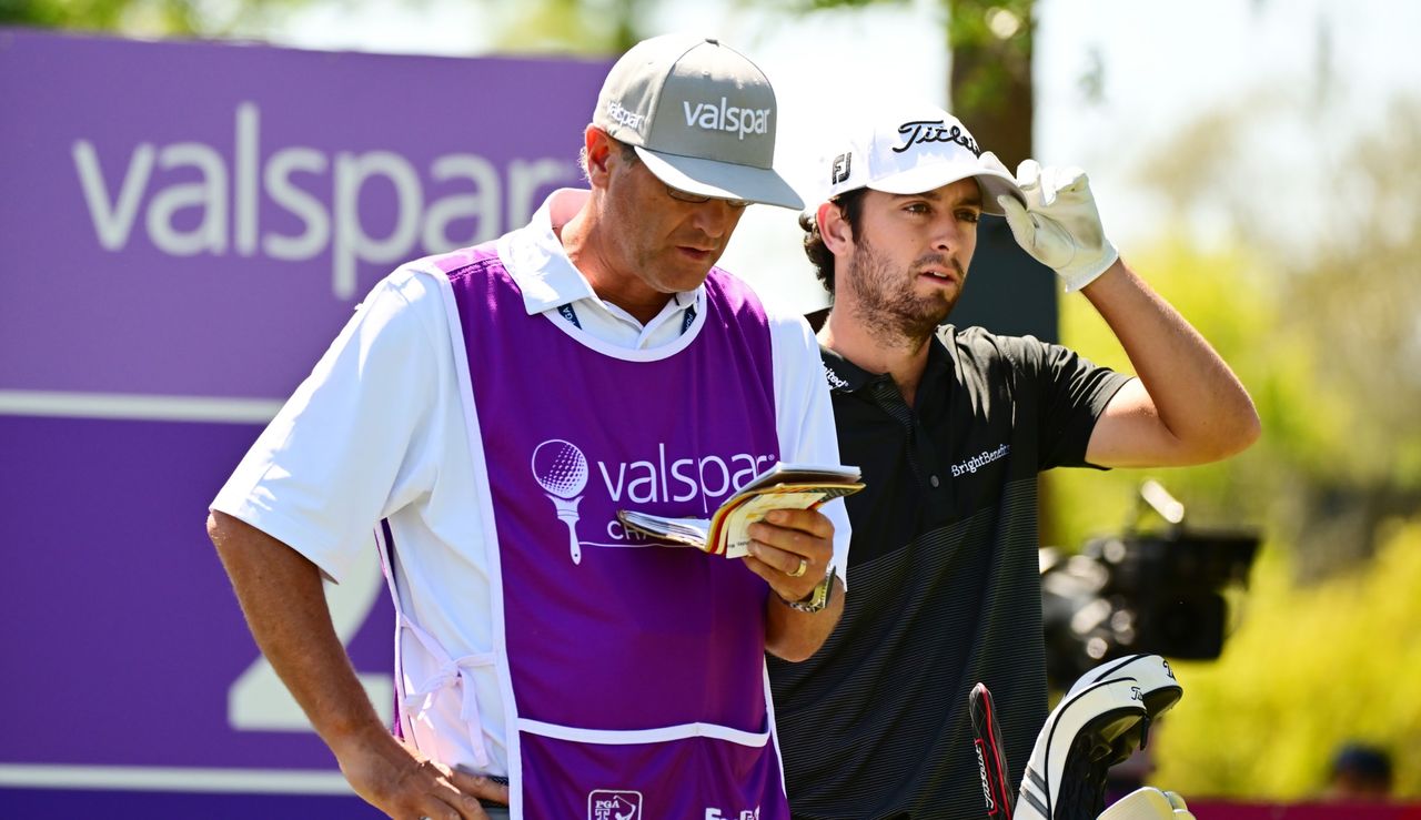 Davis Riley and caddie, Lance Bennett discuss a shot