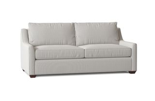 A striped sleeper sofa with curved arms