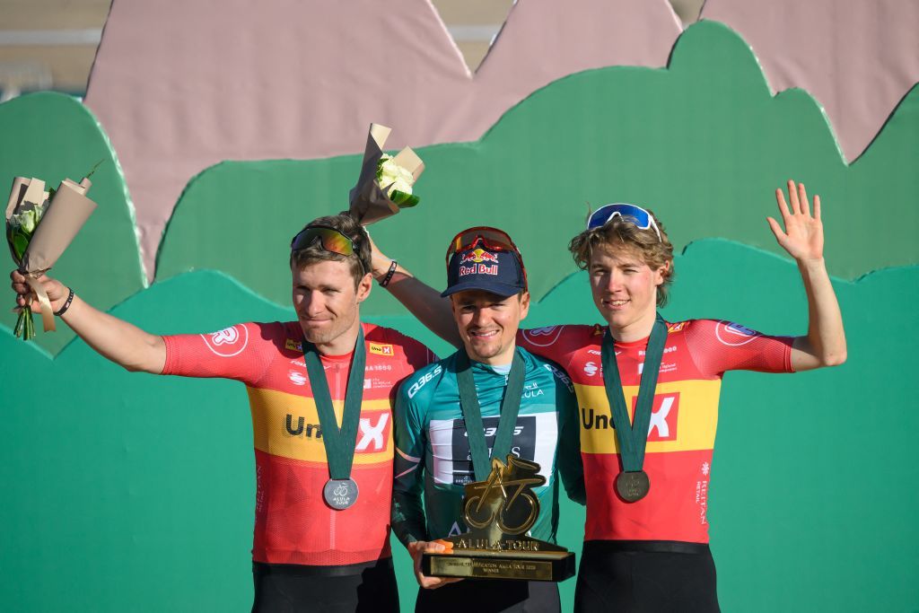 Team Q36.5 Pro Cycling Team British rider Tom Pidcock (C) celebrates on the podium with second-placed Uno-X Mobility's team Norvegian rider Fredrik Dversnes (L) and third-placed Uno-X Mobility's team Norvegian rider Johannes Kulset after winning the overall AlUla Tour cycling race, after the fifth stage of the race from AlUla Camel Cup track to AlUla Camel Cup track on February 1, 2025. (Photo by Loic VENANCE / AFP)