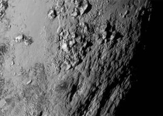 New Horizons' first detailed image of the heart-shaped 'Tombaugh Regio' near Pluto's equator revealed a range of mountains rising as high as 11,000 feet above the icy body.