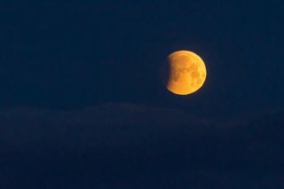 Skywatcher Shenandoah Sanchez captured this view of the partial lunar eclipse visible at dawn on April 4, 2015 from Dulles International Airport in Virginia. While Sanchez only saw a partial eclipse, a total lunar eclipse was visible from other locations