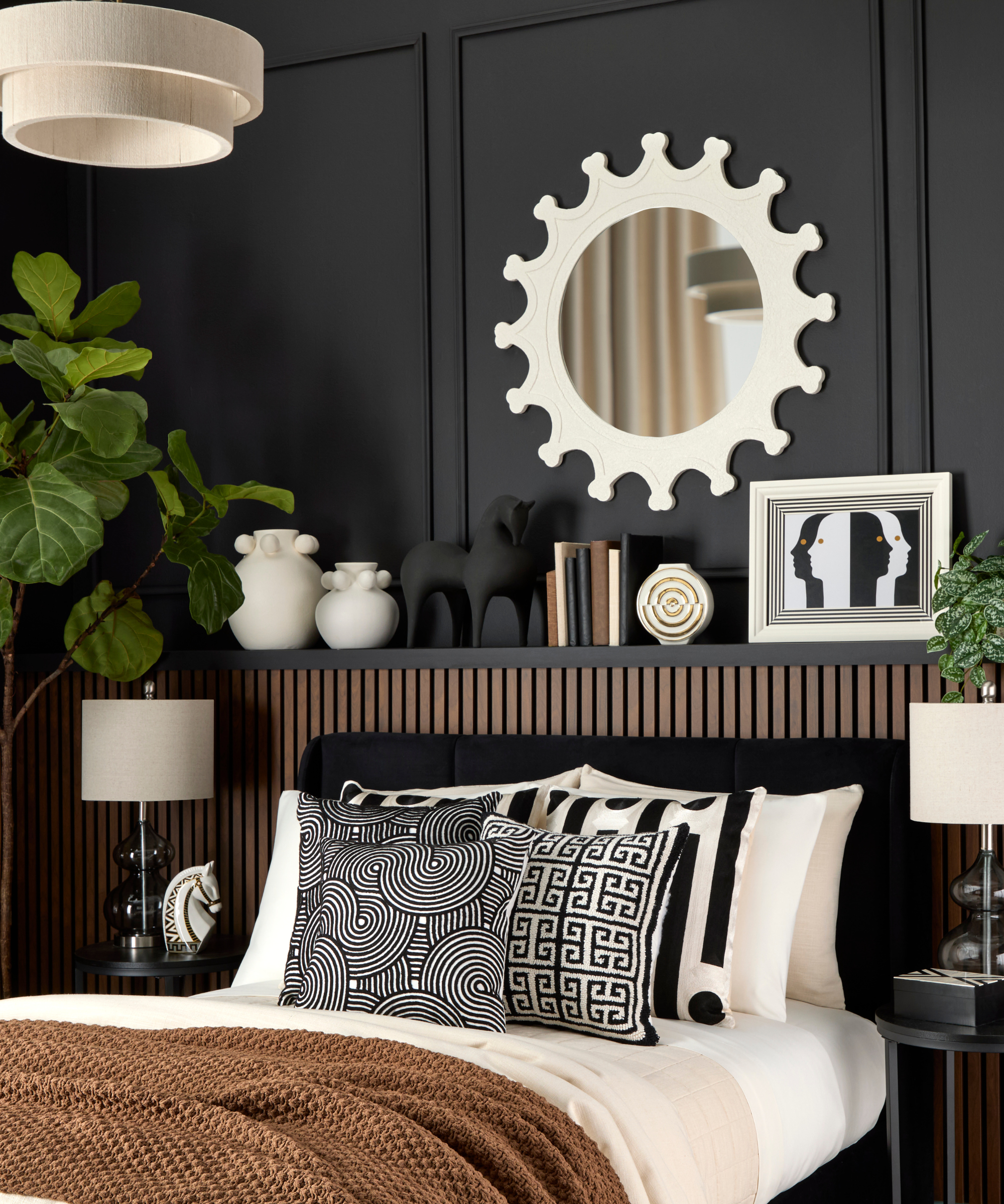 a bedroom with black painted walls, decor on the shelves, and brown and black bedding