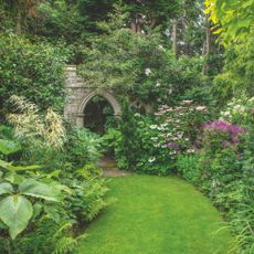 garden with lawn and stone arch