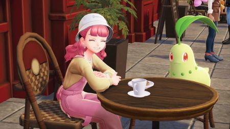 A pink-haired trainer and a Chikorita sit outside a cafe in Pokemon Legends: Z-A.