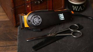 A flatlay of a beard trimmer and scissors