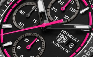 black watch dial with pink details