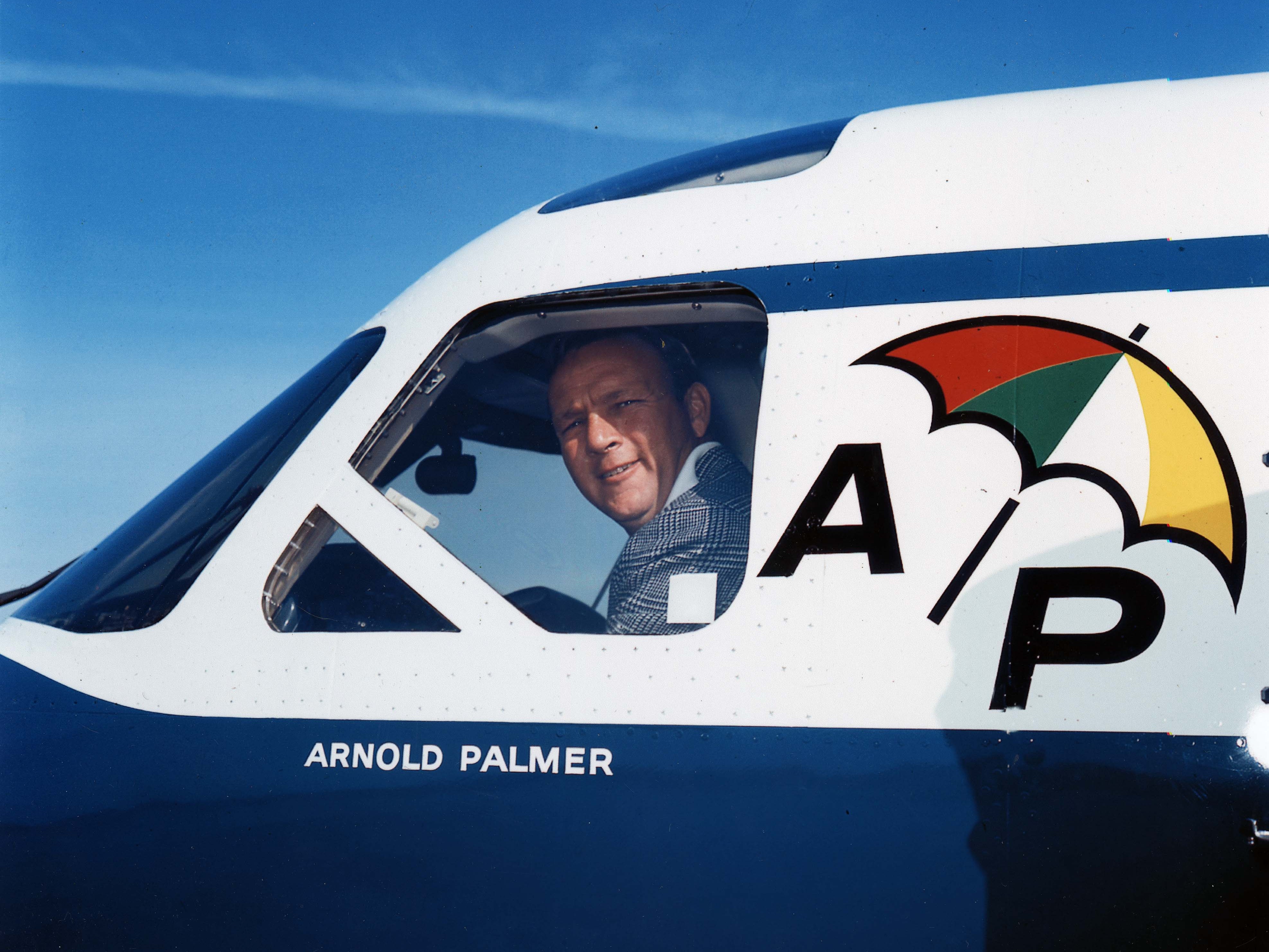Arnold Palmer looks out of the window of his branded jet from the pilot&#039;s seat