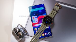 Samsung ecosystem of devices including the Galaxy S25 Ultra, Galaxy Watch Ultra, Buds 3 Pro, Samsung laptop, and Tab S10 Ultra