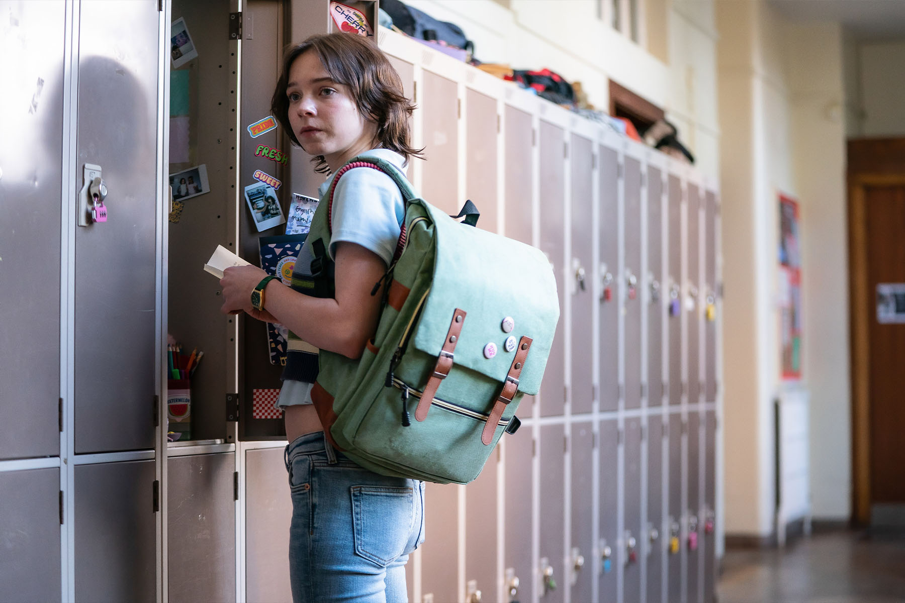 Emma Myers as Pip standing in front of lockers in season 2 of A Good Girl's Guide to Murder.