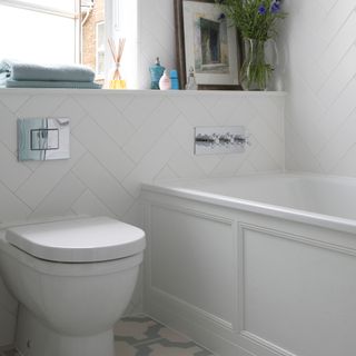 bathroom with white wall tiles and classic bath panelling