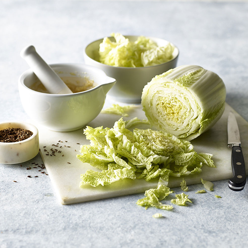 kitchen workboards with white bowl and green vegetables