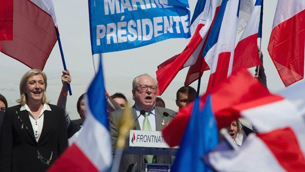 Jean-Marie Le Pen (L) and Marine Le Pen (R) stand on stage during French National Anthem