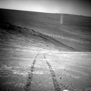 Opportunity captured a dramatic photograph of its own tracks and a dust devil on March 31, 2016.