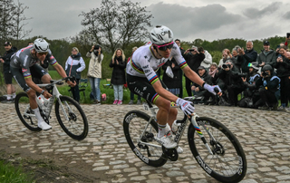 Alpecin-Deceuninck's Dutch rider Mathieu van der Poel (L) and UAE Team Emirates Slovenian rider Tadej Pogacar cycle in a breakaway in a paved area during the 122nd edition of the Paris-Roubaix