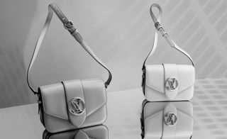 View of two Louis Vuitton ‘Pont 9’ bags, one in white and one in grey on a reflective surface pictured against a grey background