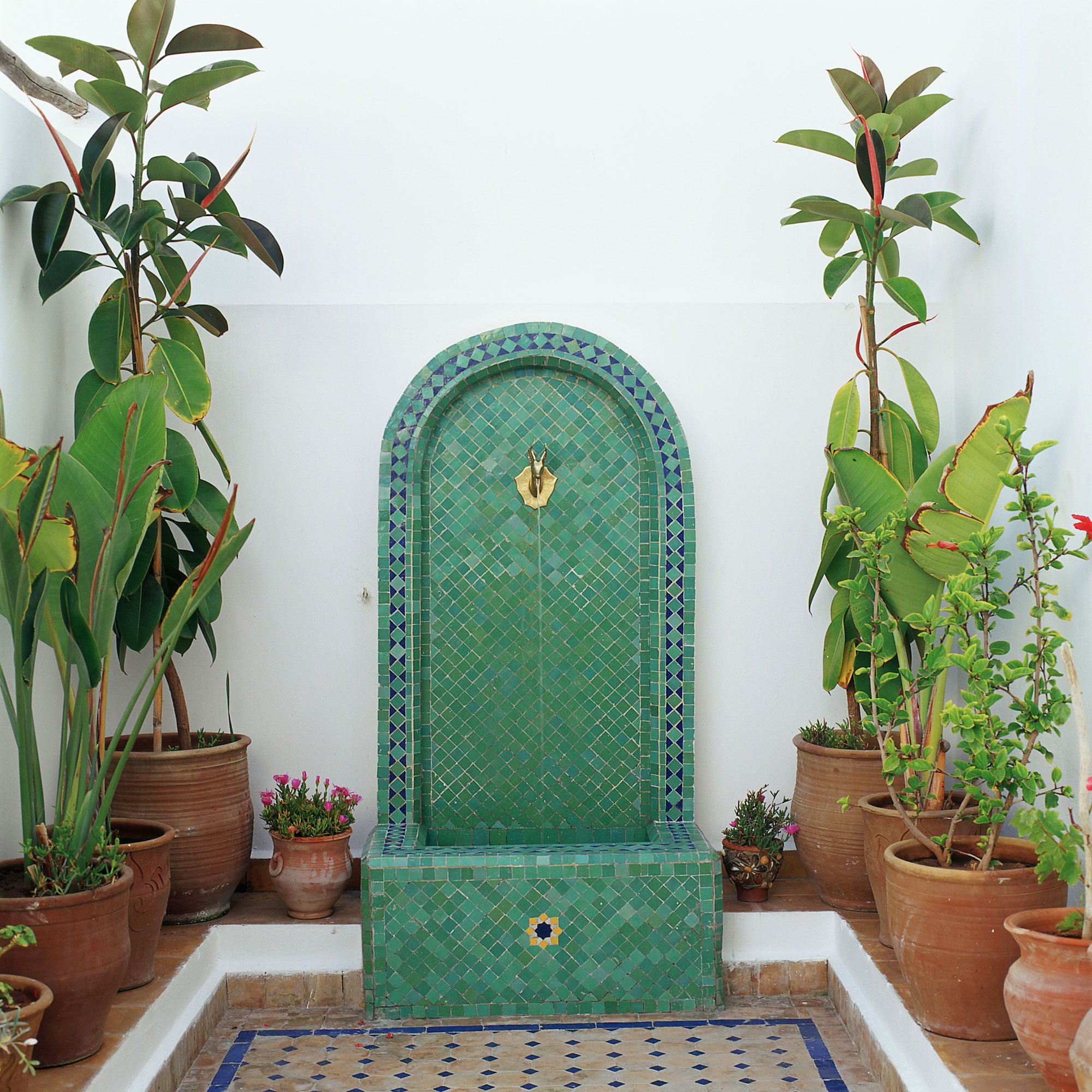 mosaic design water feature and plant in pots