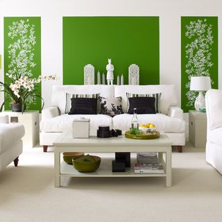 living room with green wall and white sofa