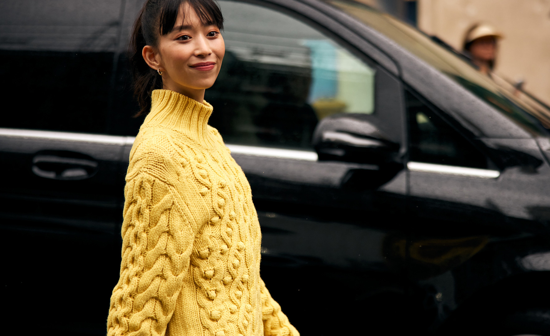 woman wearing yellow sweater on the street