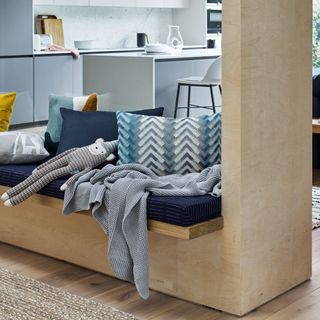 kitchen area with blue couch and worktop