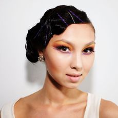 model with long luscious eyelashes and pinned-back hair