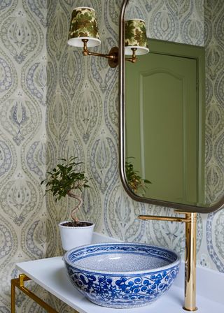 Small bathroom with clashing patterns and china basin