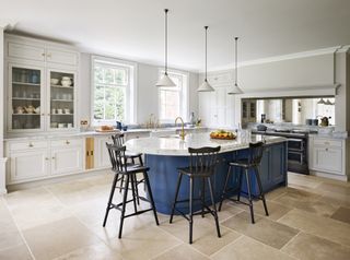 a curved kitchen island idea in bright blue