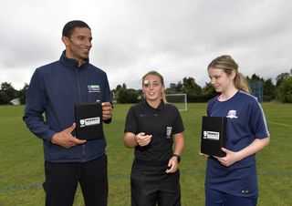 David James, referee Ella Broad and competition winner Chloe at the first Coin for Respect match