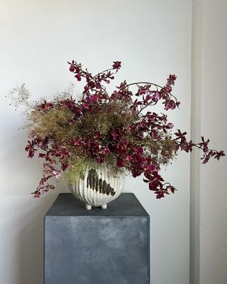 a fresh flower arrangement on a gray pedestal