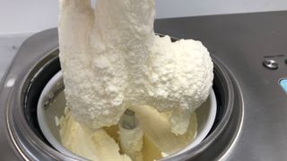 Breville Smart Scoop Ice Cream Maker making vegan vanilla ice cream. The churner is being lifted with ice cream hanging off