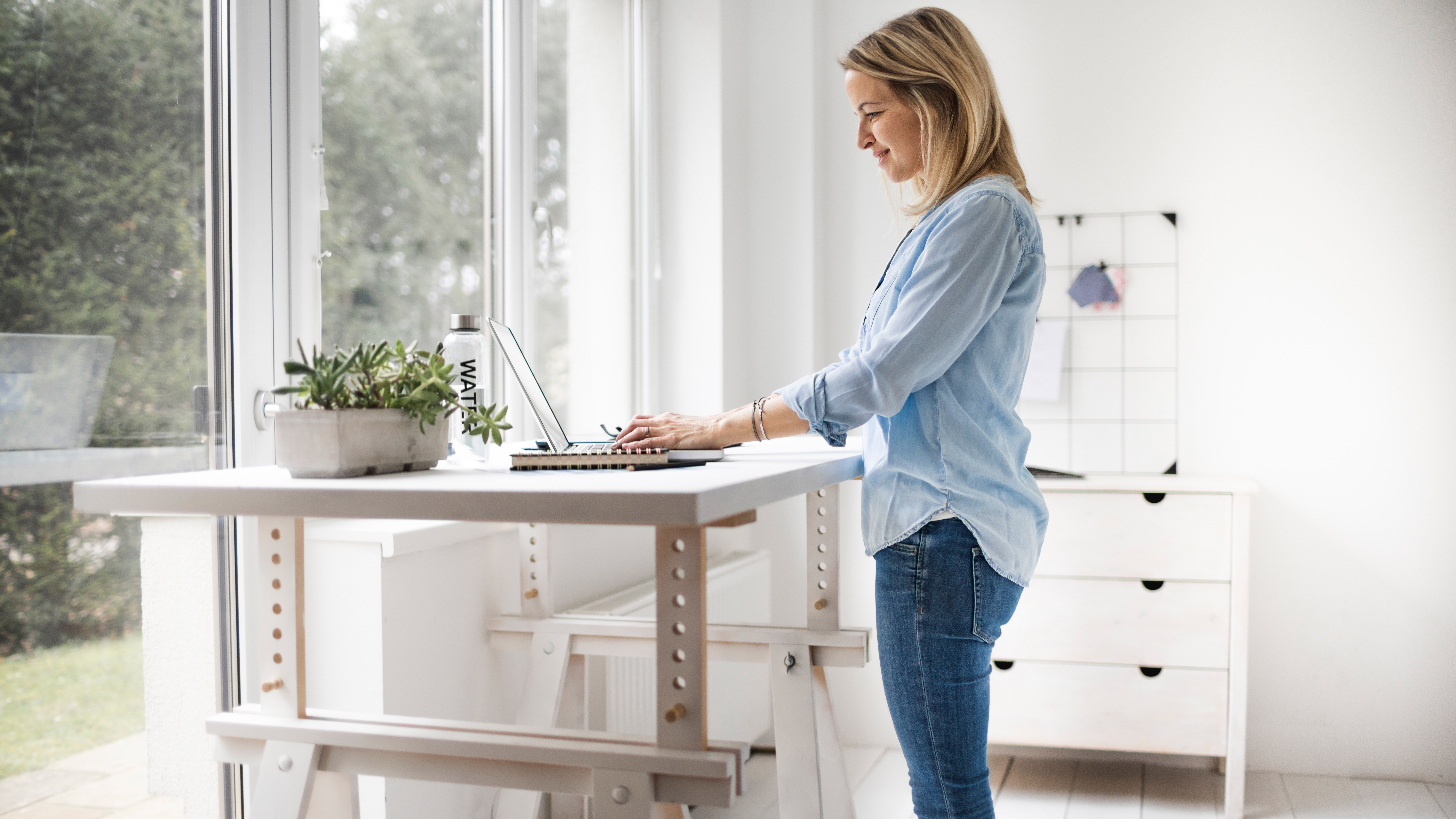 A woman working at a standing desk