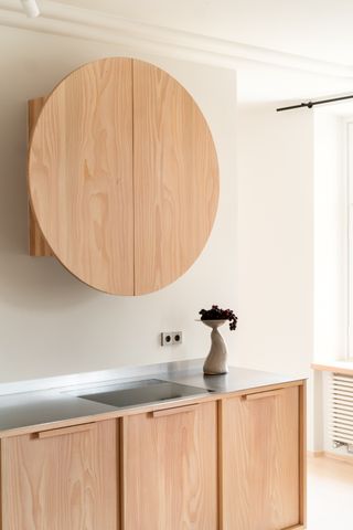wood kitchen with circular wood hood