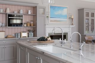 closeup of kitchen island with white quartz worktop and boiling water tap