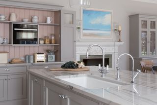 Close-up of kitchen island with white quartz worktops and boiling water tap