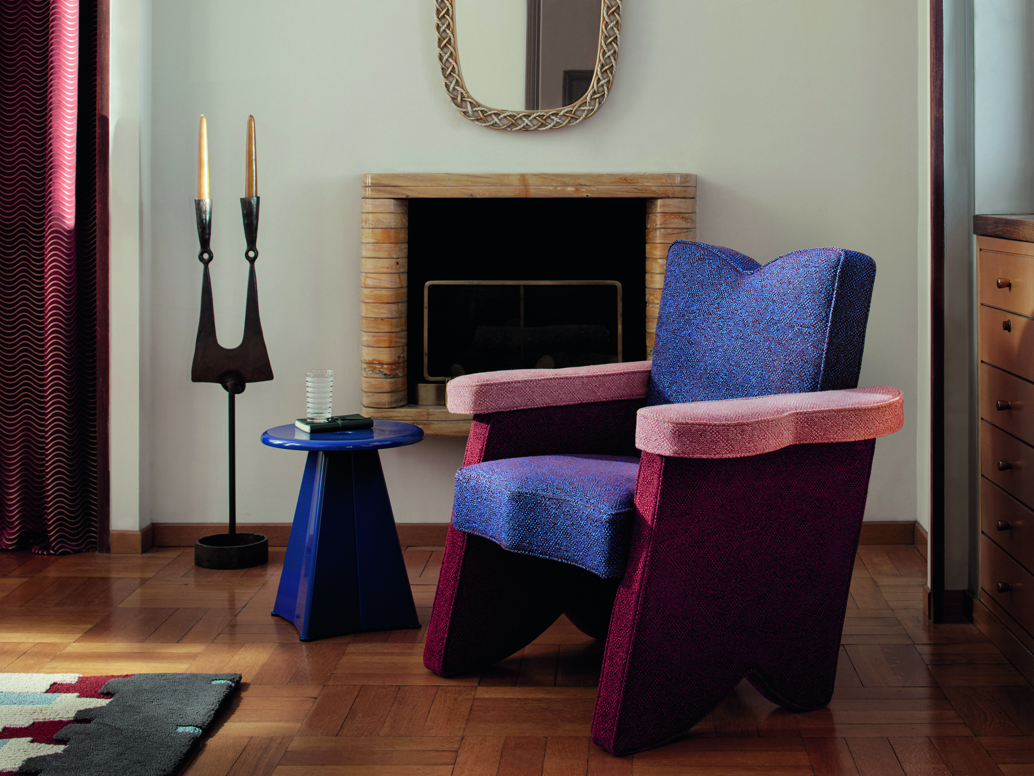 A modern seating area with a chair made from three bold fabrics