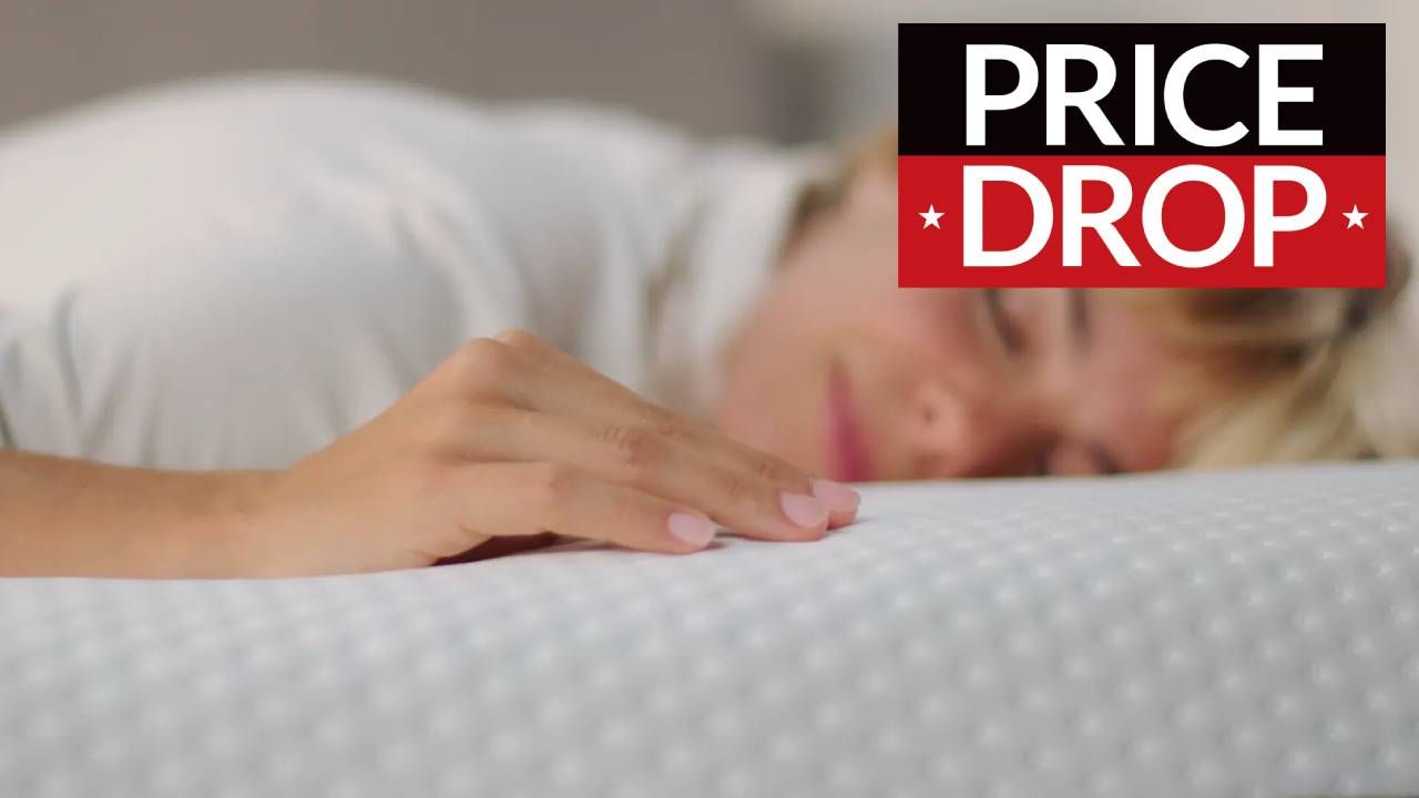 A close-up of a woman lying on the Emma NextGen Premium mattress with a T3 price drop badge