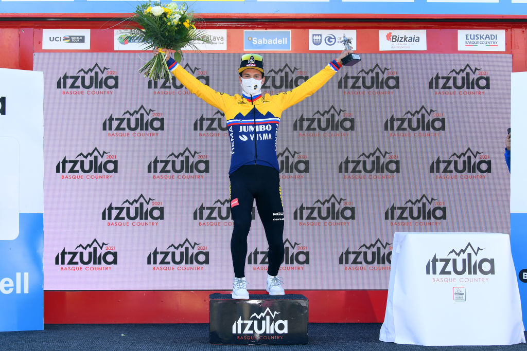 BILBAO SPAIN APRIL 05 Podium Primoz Roglic of Slovenia and Team Jumbo Visma Celebration during the 60th ItzuliaVuelta Ciclista Pais Vasco 2021 Stage 1 a 139km individual time trial from Bilbao to Bilbao Mask Covid safety measures Trophy Flowers itzulia ehitzulia ITT on April 05 2021 in Bilbao Spain Photo by David RamosGetty Images